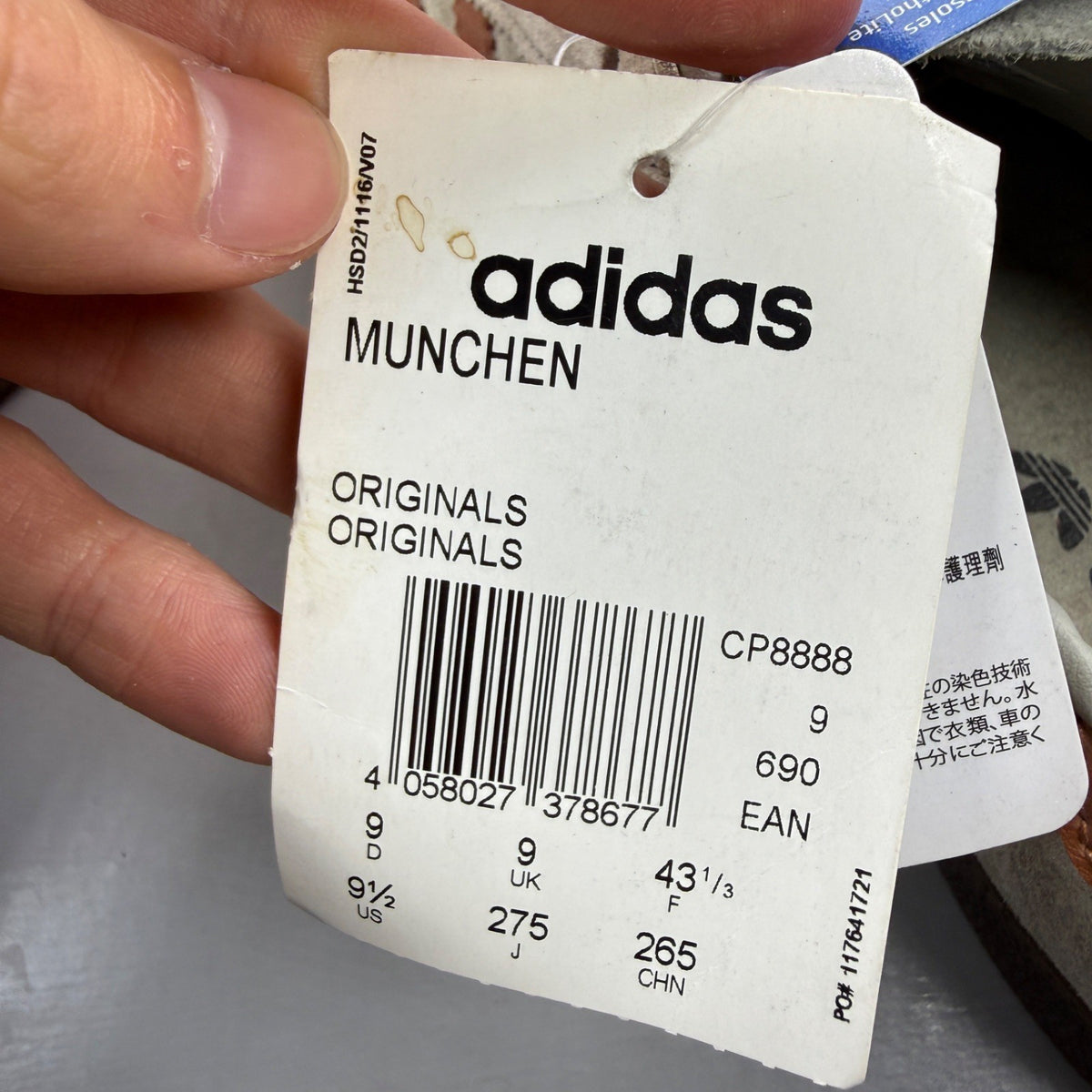 Adidas grey deck shoes with iconic three stripes and textured suede material.