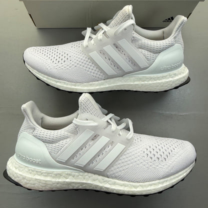 Adidas Ultra Boost 1.0 white running trainers with textured knit upper and signature three stripes.