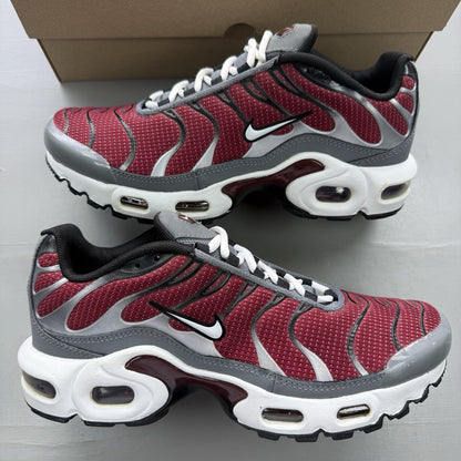 Nike Air Max Plus TN white trainers with red and black accents, featuring logo detailing.