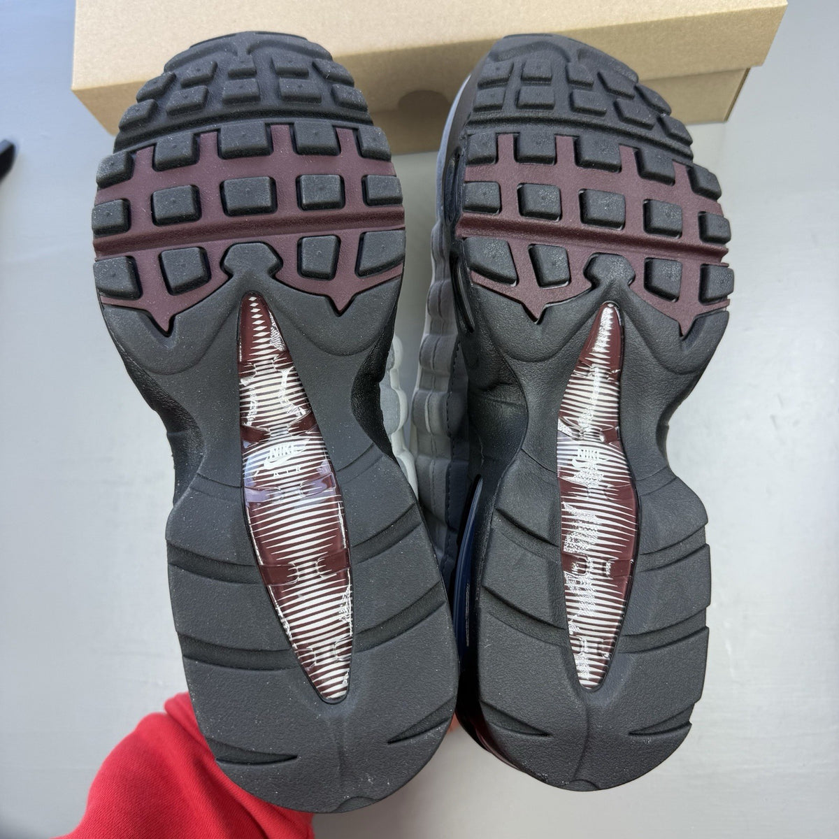 Nike Air Max 95 OG Big Bubble grey sneakers with burgundy accents and visible air cushioning.