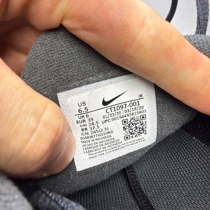 Nike Air Max Plus TN black trainers with dark smoke grey accents and logo detailing.