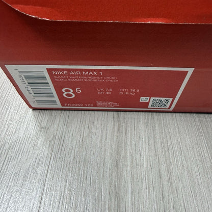 Nike Air Max 1 red trainers with white accents and signature swoosh logo.