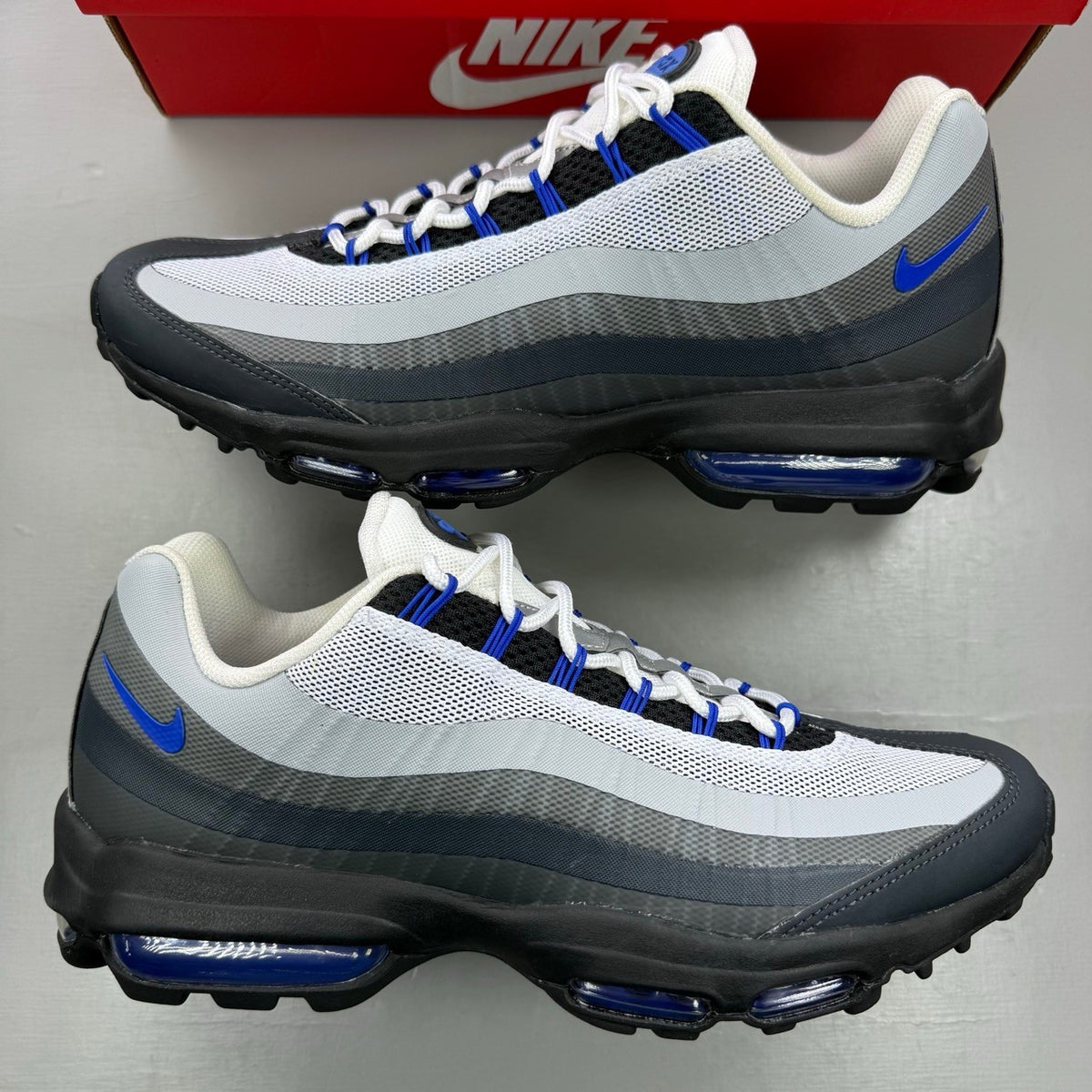 Nike Air Max 95 Ultra black with racer blue and anthracite grey accents, sleek design.
