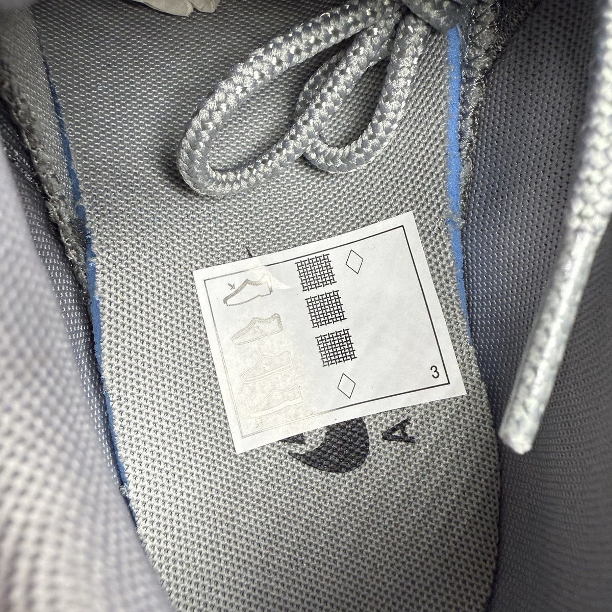 Nike Air Max 95 trainers grey with aqua blue accents and retro logo details.