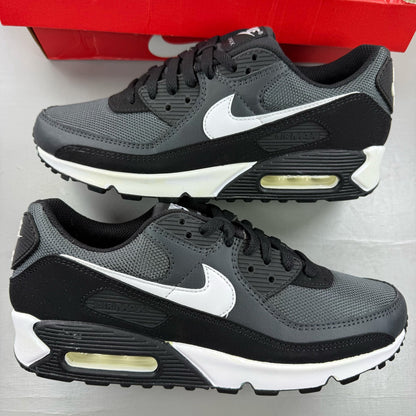 Nike Air Max 90 black trainers with grey accents and signature swoosh logo.