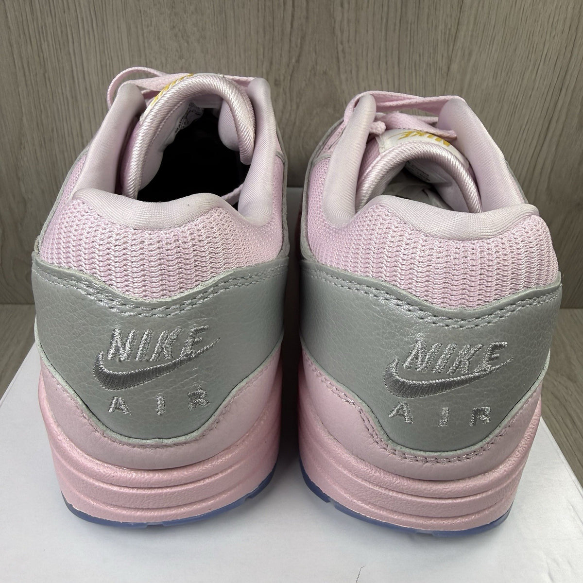 Nike Air Max 1 trainers pink with silver accents and unique design details.