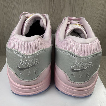 Nike Air Max 1 trainers pink with silver accents and unique design details.
