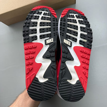 Nike Air Max 90 white trainers with red accents and logo, used condition.