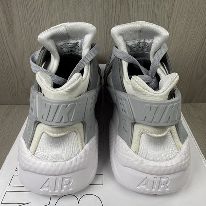 Nike white trainers with grey accents and signature logo on the tongue.