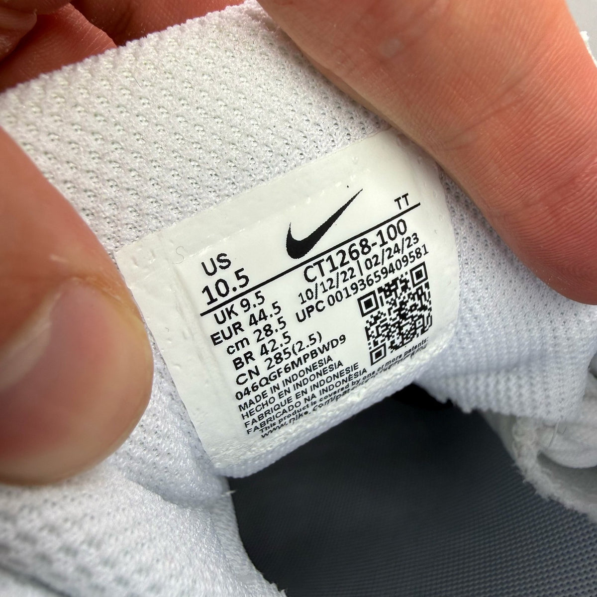 Nike Air Max 95 white trainers with mesh and leather upper, reflective accents.