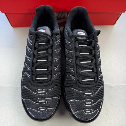 Nike Air Max Plus TN black trainers with university red accents and visible logo details.