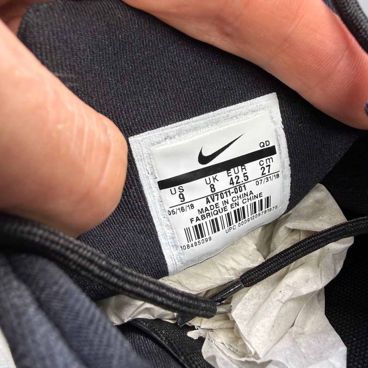 Nike black trainers with white accents and sleek design, featuring logo details.