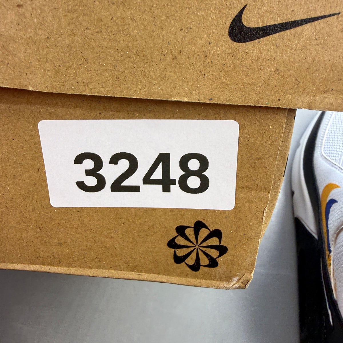 Nike Air Max 90 white athletic shoes featuring double swoosh logo and sleek design.
