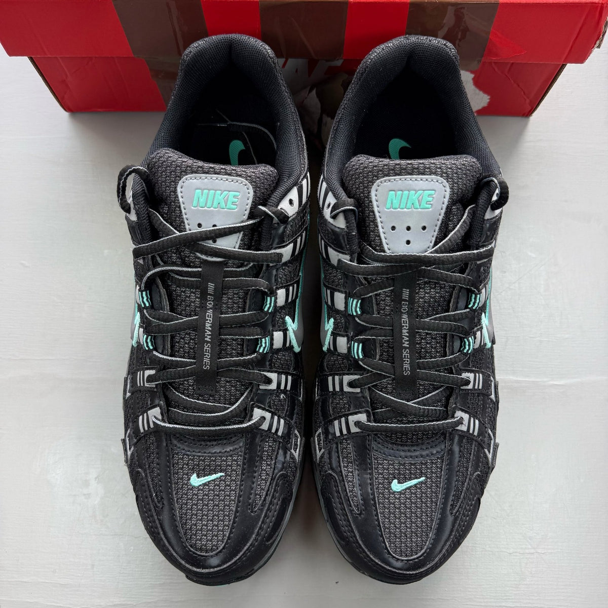 Nike P-6000 black trainers with hyper turquoise accents and grey detailing.