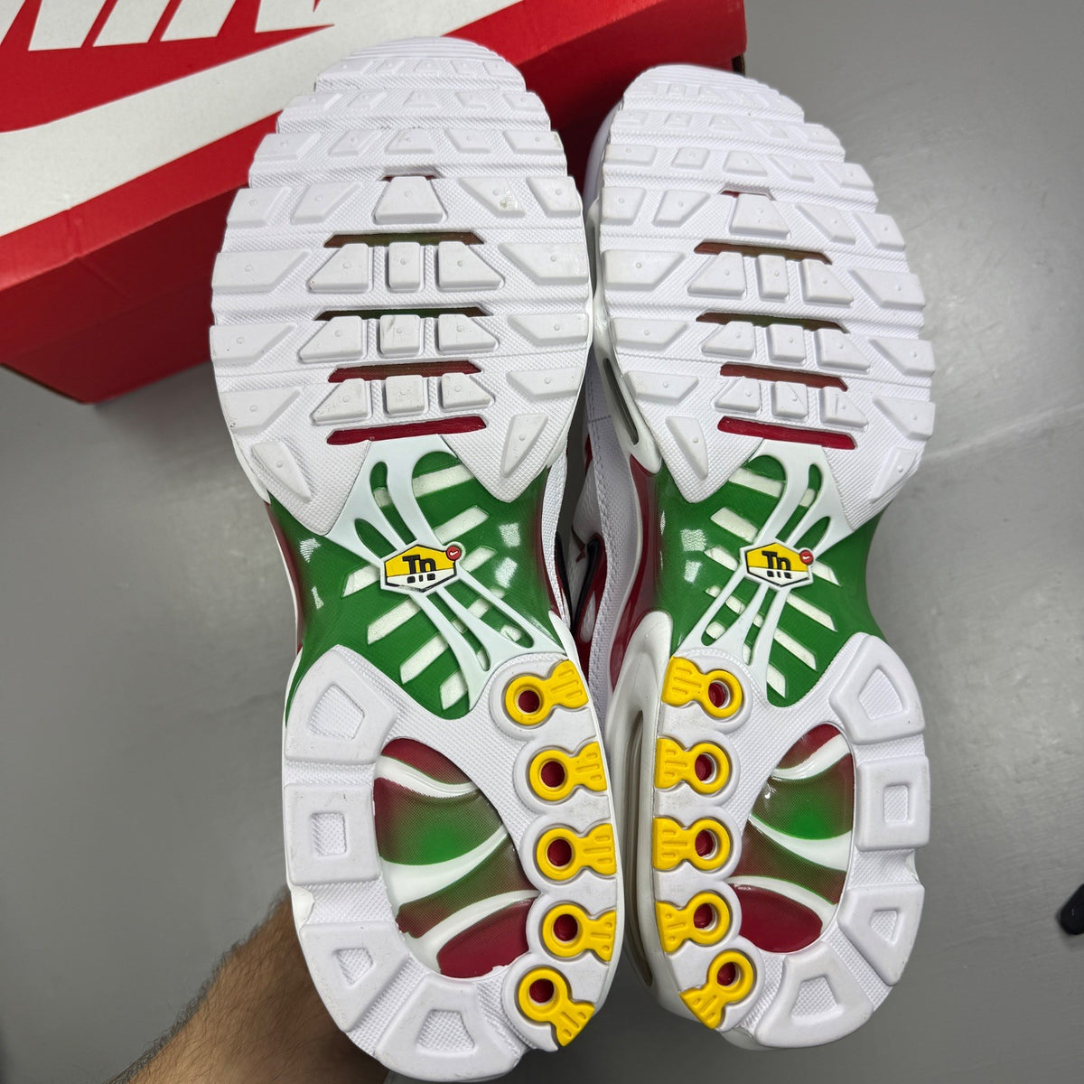 Nike deck shoes white with green and red accents, featuring logo and sleek design.