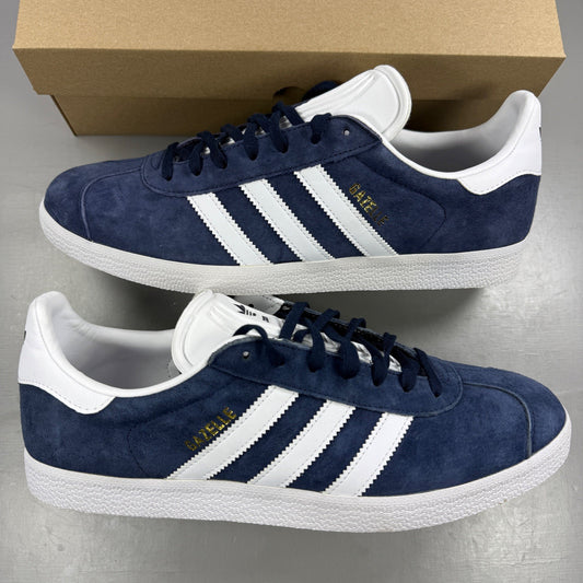 Adidas blue suede trainers with white stripes and logo detailing.