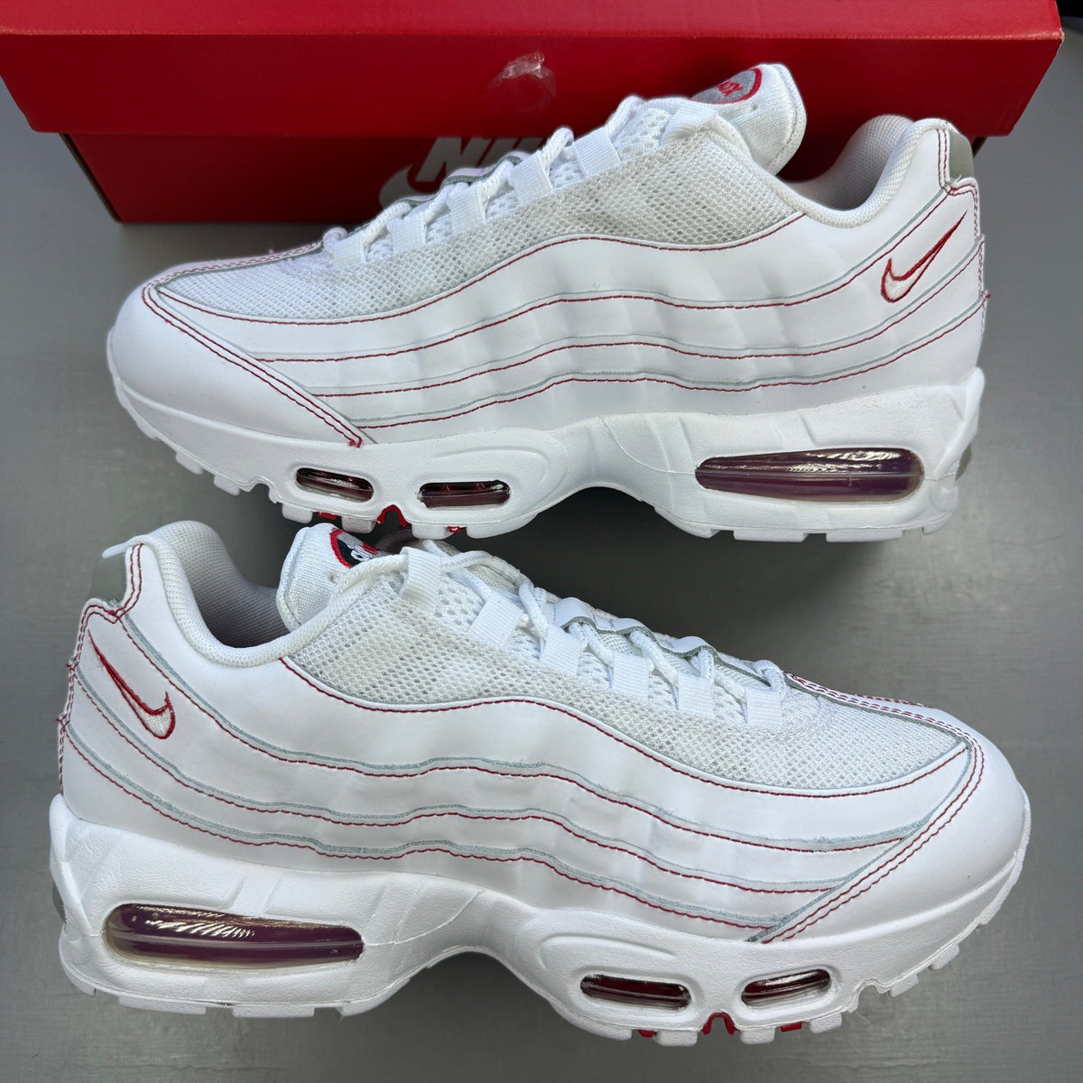 Nike trainers white with red accents and big bubble sole design.