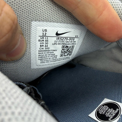 Nike grey trainers with blue accents and mesh material, featuring iconic swoosh logo.