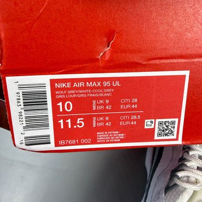 Nike Air Max 95 white trainers with grey accents and signature swoosh logo.