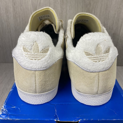 Adidas Gazelle trainers ecru tint with white stripes and suede upper material.