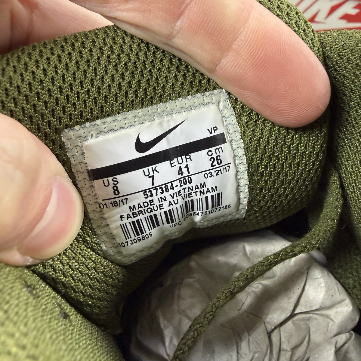 Nike Air Max 90 Essential green trainers with khaki accents and signature swoosh logo.