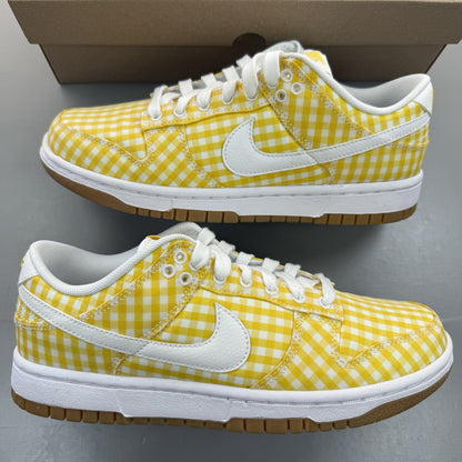 Nike Dunk Low white trainers with yellow gingham pattern and brown gum sole.