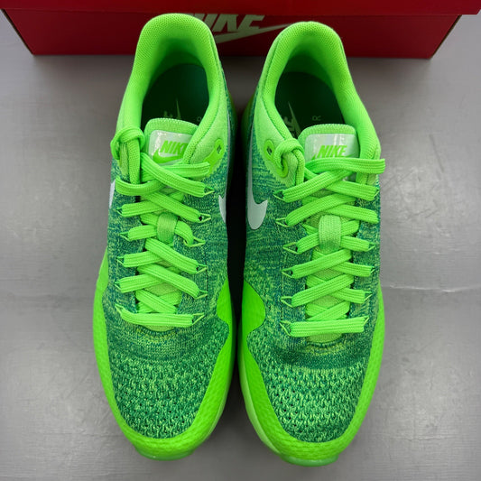 Nike trainers green Flyknit upper with Air Max cushioning and logo detail.