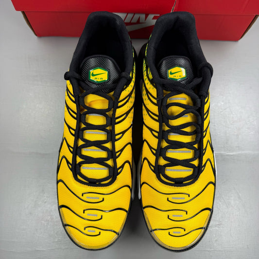 Nike Air Max Plus trainers yellow with pine green accents and logo detail.
