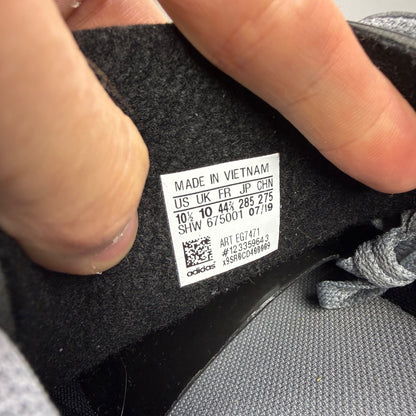 Adidas grey deck shoes with white accents and classic logo detailing.