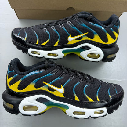 Nike Air Max Plus TN black trainers with teal and yellow accents, featuring logo detailing.