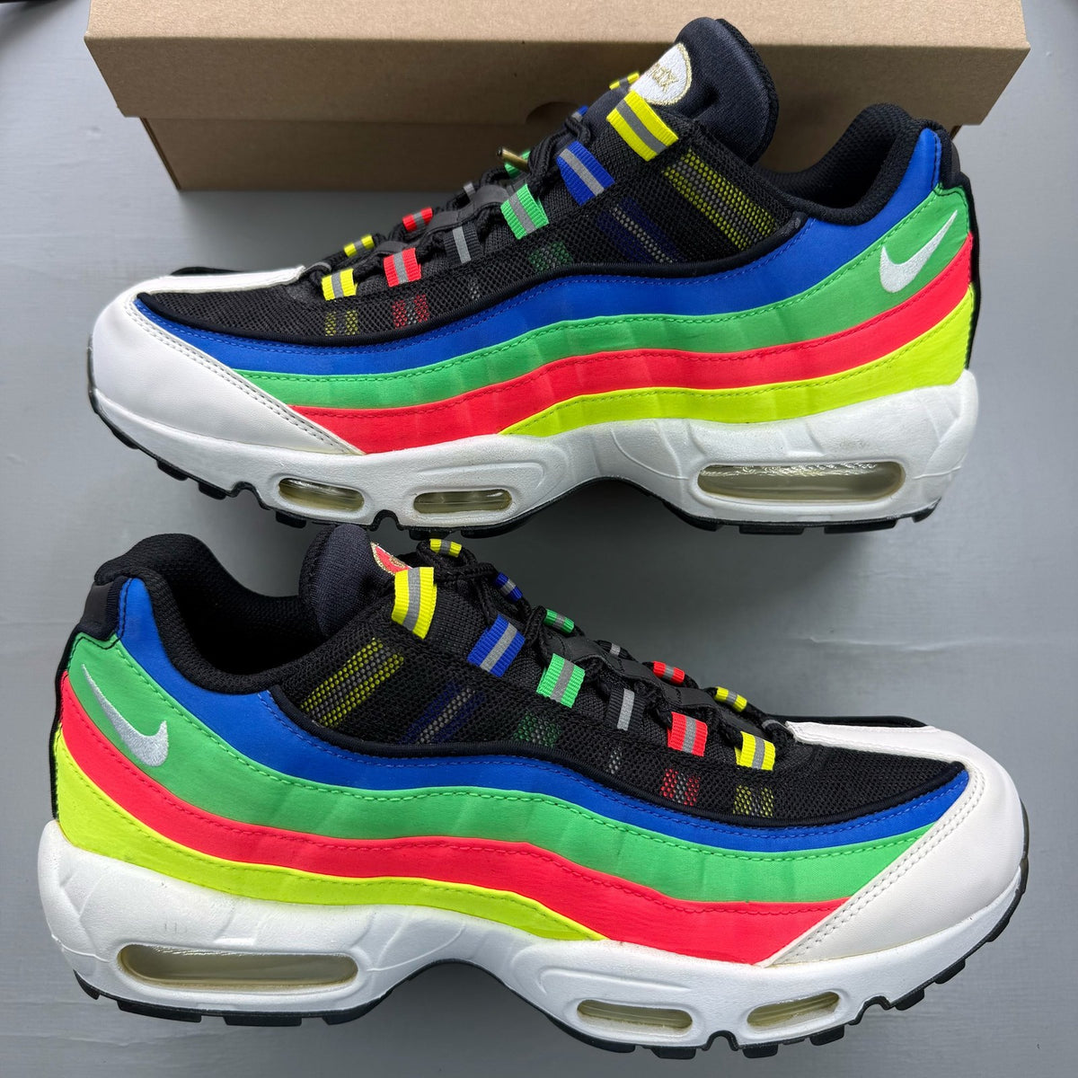 Nike black Air Max 95 trainers with hidden message detail and sleek design.