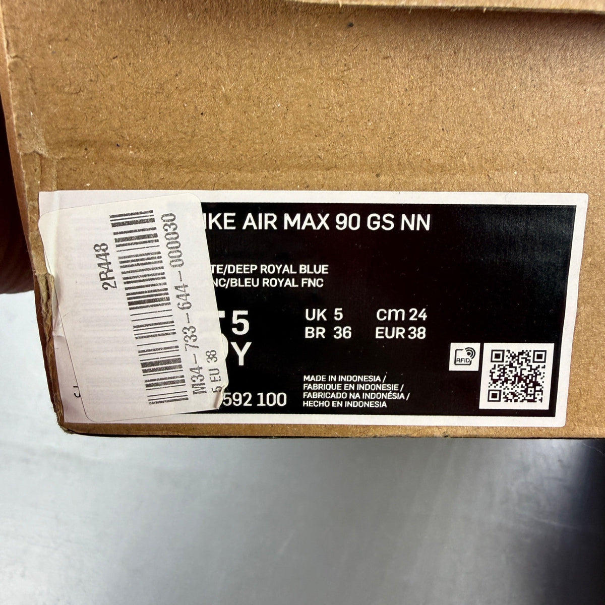 Nike Air Max 90 white athletic shoes featuring double swoosh logo and sleek design.
