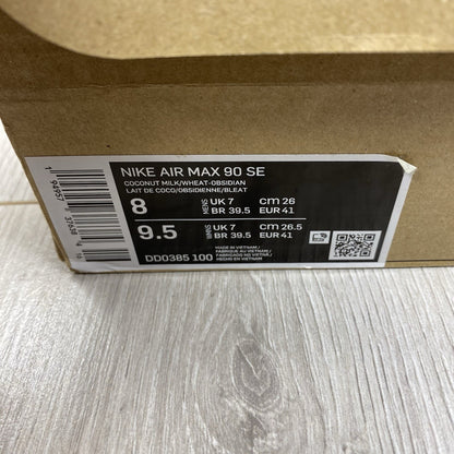 Nike Air Max 90 SE white trainers with cork accents and logo detail.