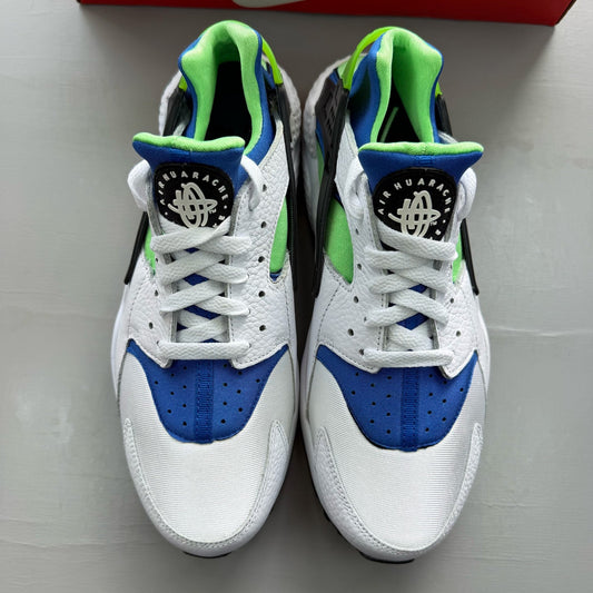 Nike Air Huarache white trainers with scream green and blue accents, mesh material.