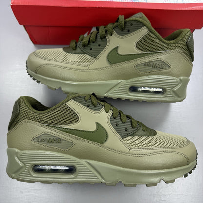 Nike Air Max 90 Essential green trainers with khaki accents and signature swoosh logo.