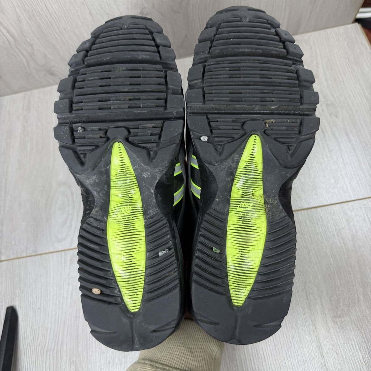Nike Air Max 95 NDSTRKT black trainers with neon accents and textured mesh upper.