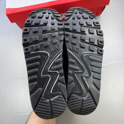 Nike Air Max 90 Premium black trainers with silver reflective accents and logo details.