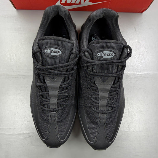Nike black deck shoes with cool grey accents and signature swoosh logo.