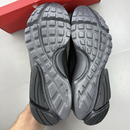 Nike Presto Fly black trainers with dark grey accents and logo detail.