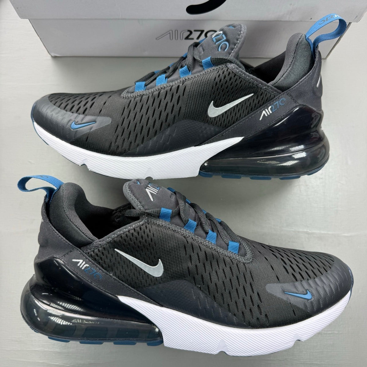 Nike Air Max 270 grey sneakers with anthracite and industrial blue accents.