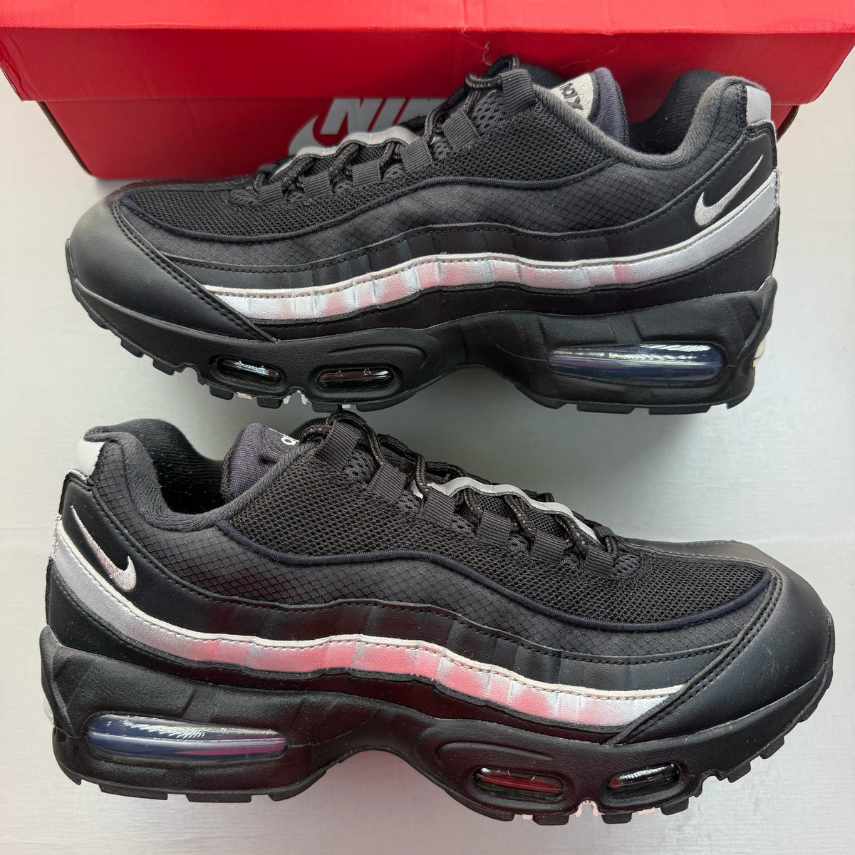 Nike Air Max 95 black sneakers with metallic silver accents and big bubble sole design.