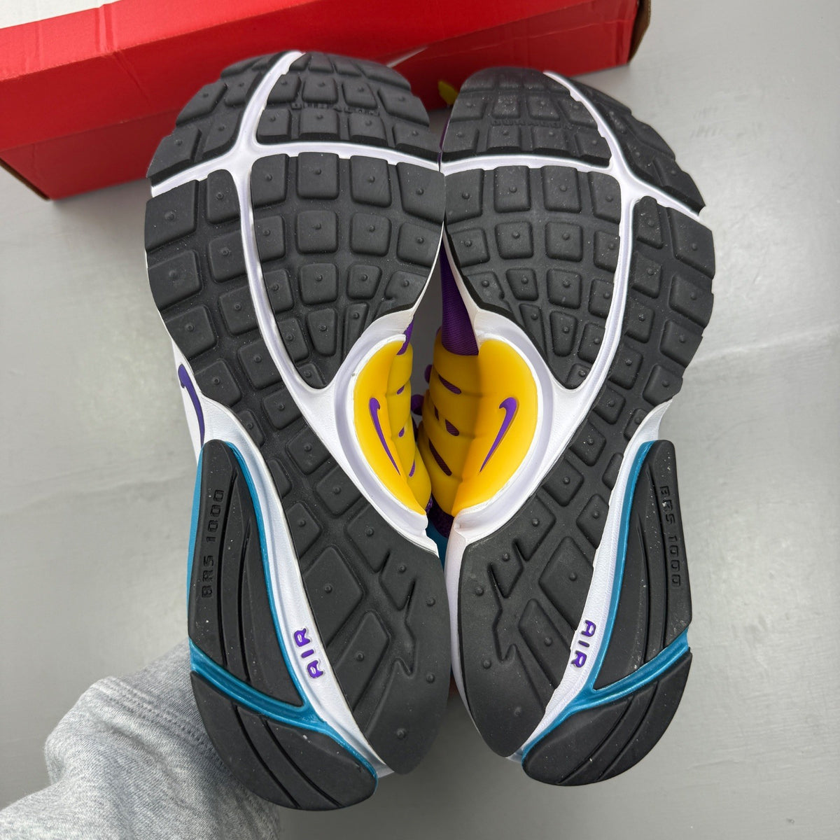 Nike Air Presto purple trainers with mesh upper and distinctive logo detailing.