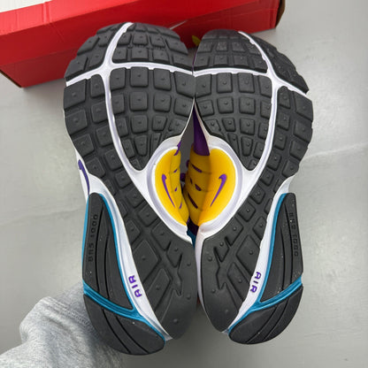 Nike Air Presto purple trainers with mesh upper and distinctive logo detailing.