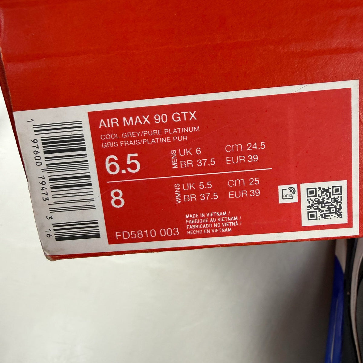 Nike Air Max 90 grey sneakers with Gore-Tex material and blue accents.
