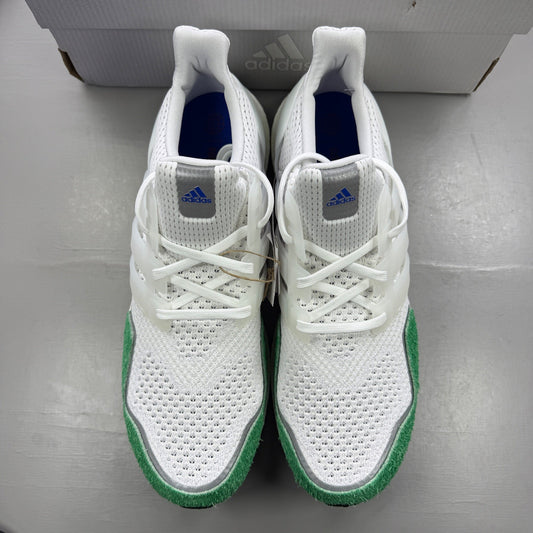 Adidas white trainers with green accents and iconic three-stripe logo.