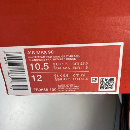 Nike Air Max 90 grey trainers with red accents and gum sole, featuring logo details.