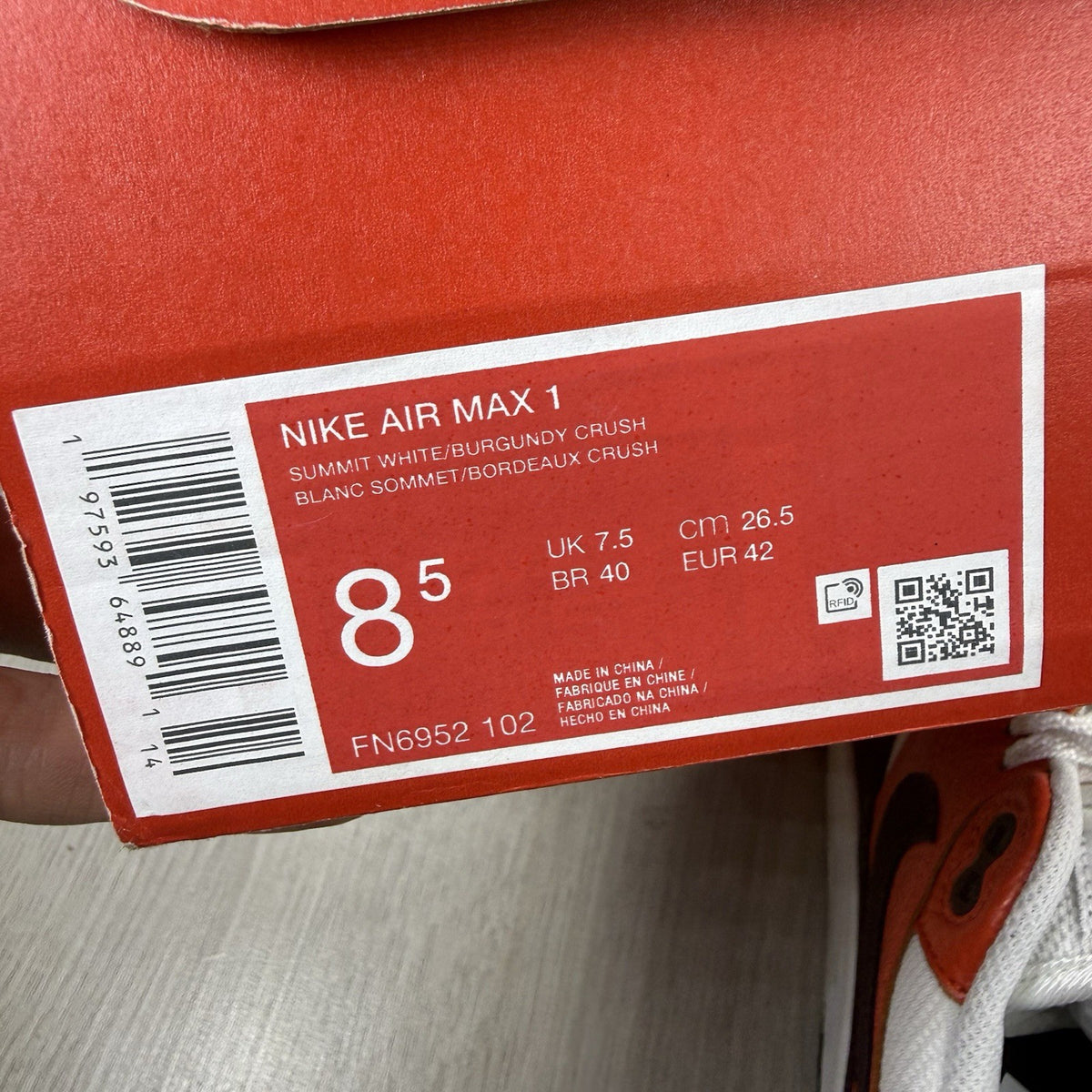 Nike Air Max 1 red trainers with white accents and signature swoosh logo.
