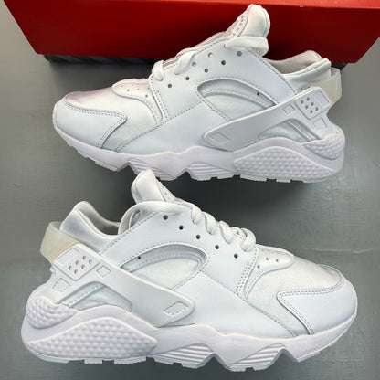 Nike Air Huarache white trainers with textured upper and signature logo detail.