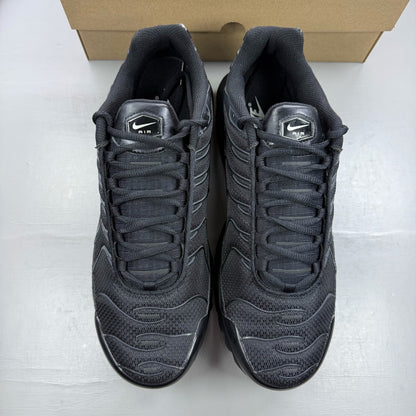 Nike Air Max Plus TN black trainers with distinctive wave pattern and logo detail.