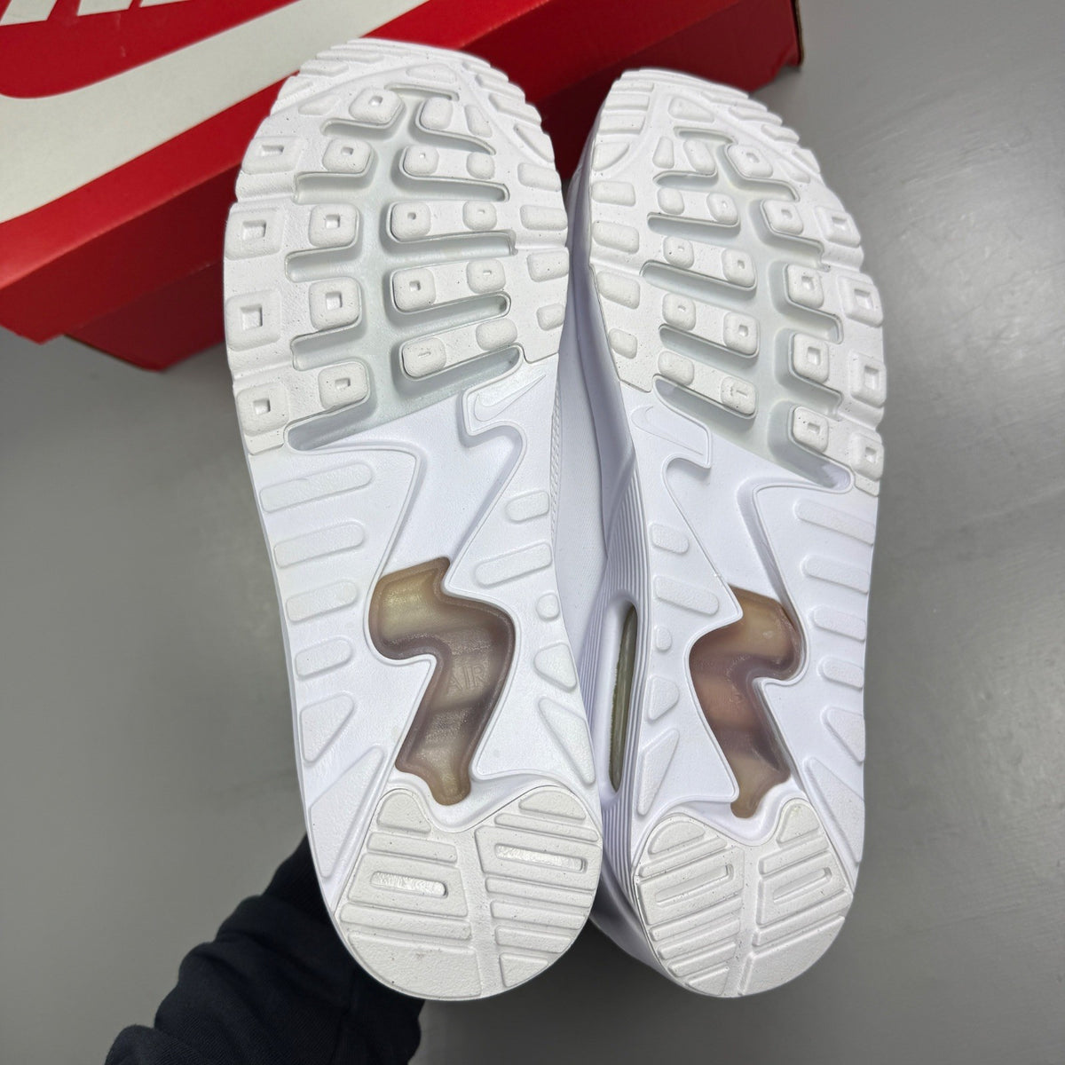 Nike trainers white mesh upper with signature swoosh logo and cushioned sole.